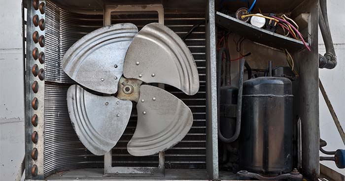 Image: the inside of a condenser unit. The compressor is an important part of any HVAC system.