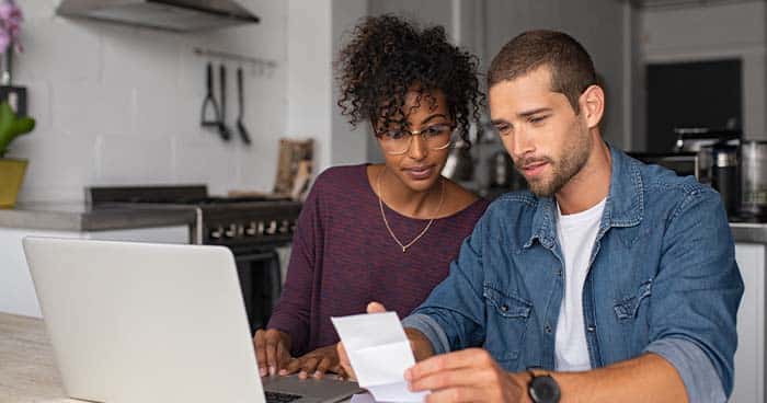 Image: a couple are looking at their bills.